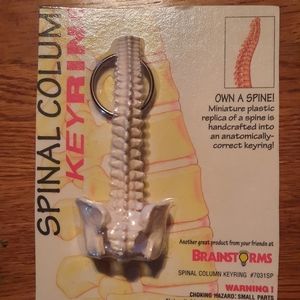 Keychain miniature replica of the spine. New still in package without tag